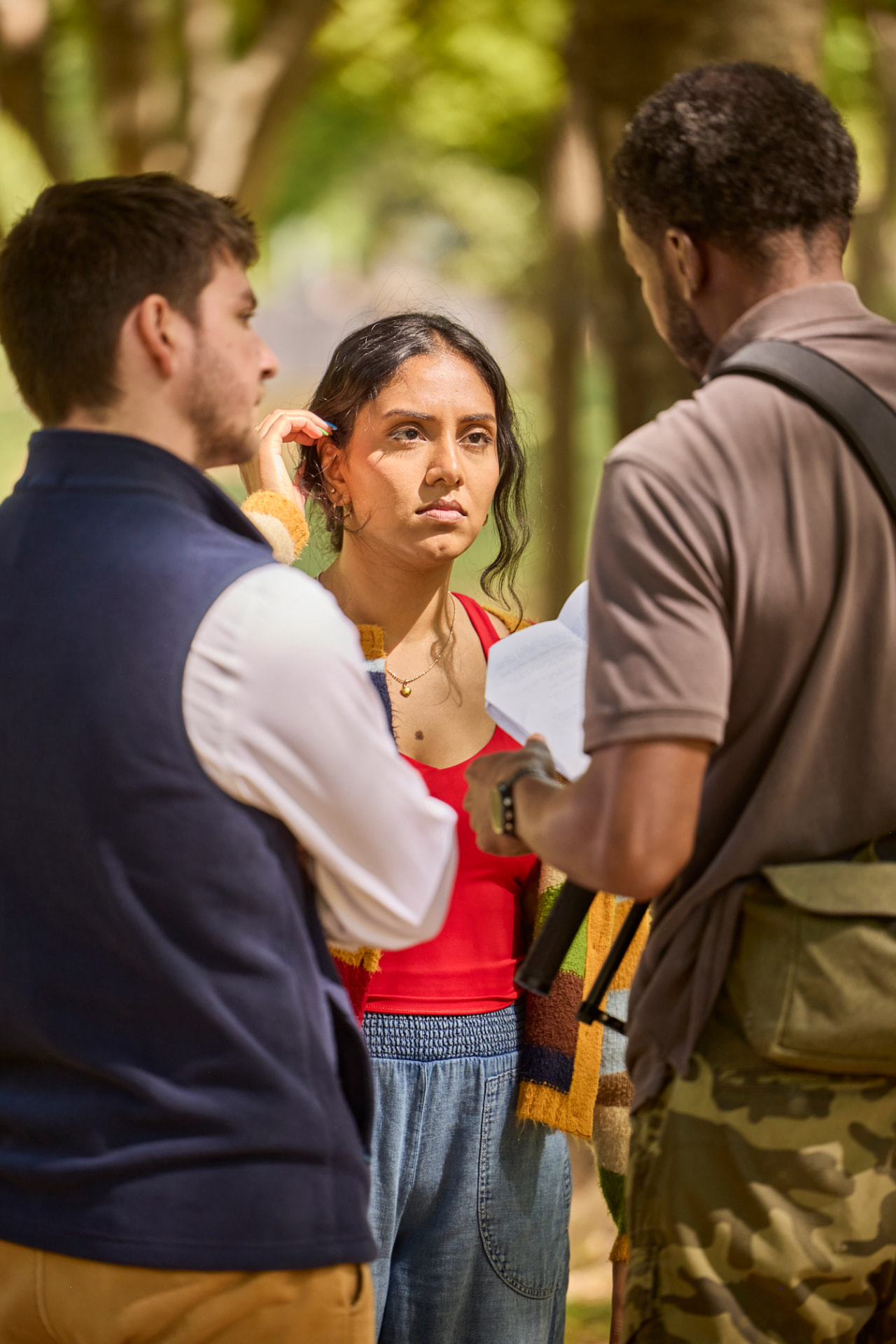 Crew members talking over a scene in the park