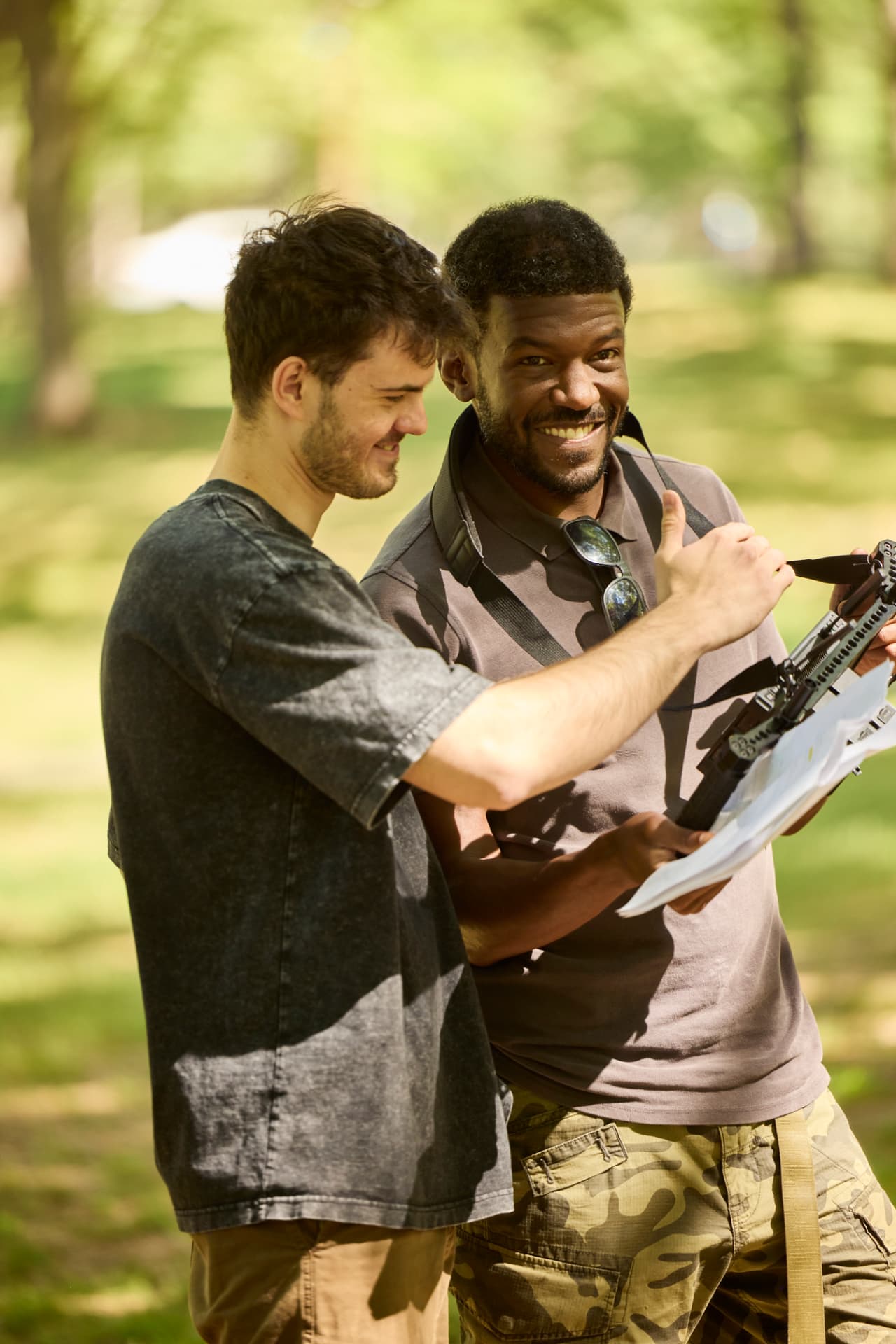 Two crew members reviewing a script in the park