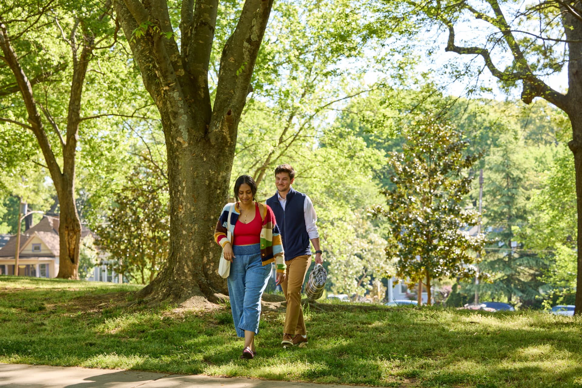 Saanvi and Nate walking through a sunny park