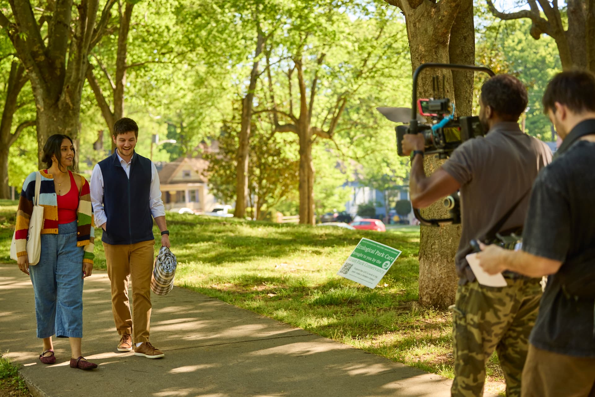 Crew filming Saanvi and Nate walking in the park